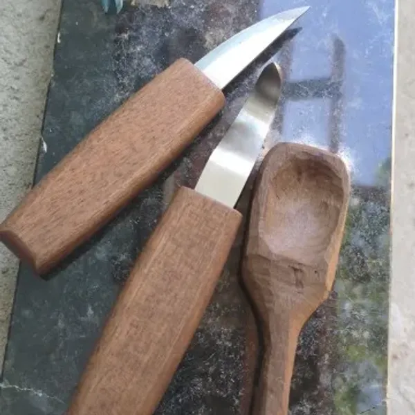 Spoon carved by a verified buyer in Brazil with the CarveKind kit, photographed alongside the tools